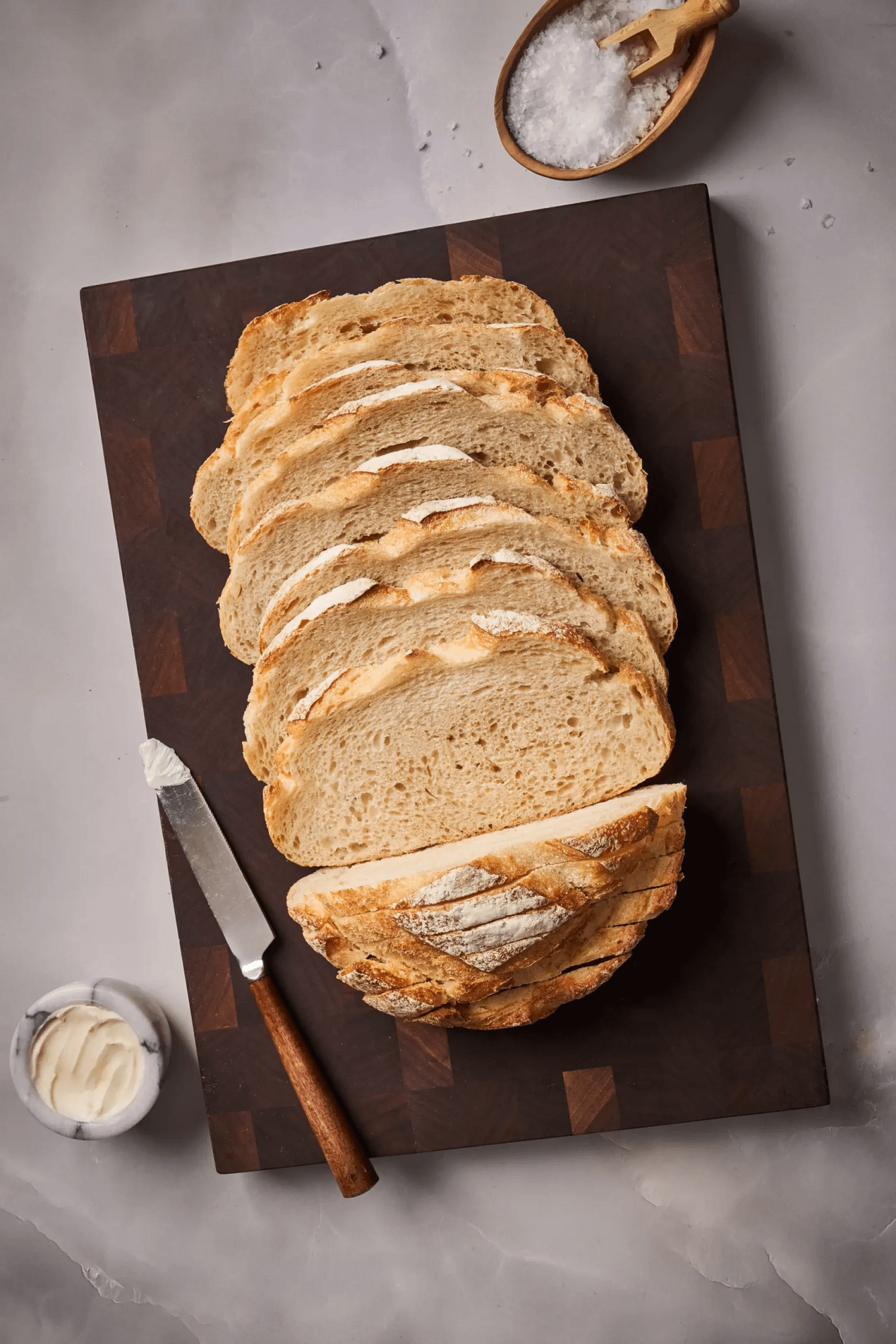 Rustic italian boule sliced on a cutting board