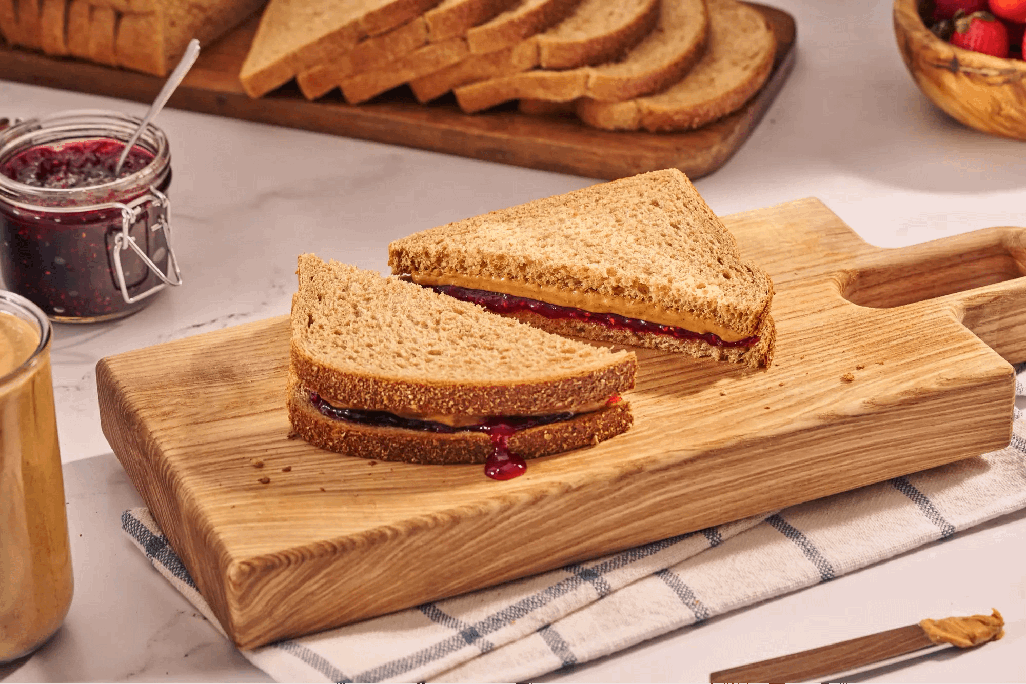 Whole wheat sandwich cut in half on cutting board